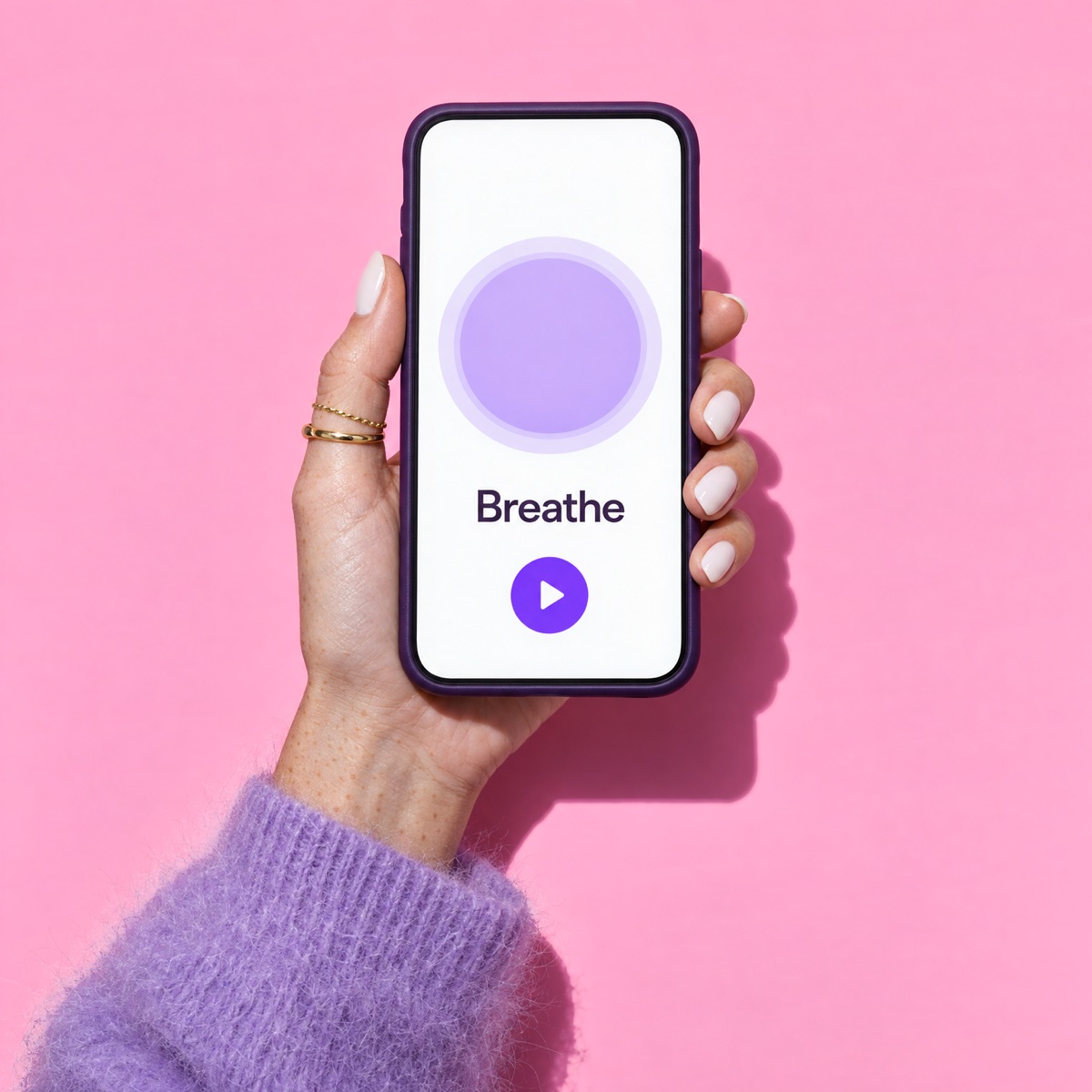 Hand holding a phone with the Aura meditation app.